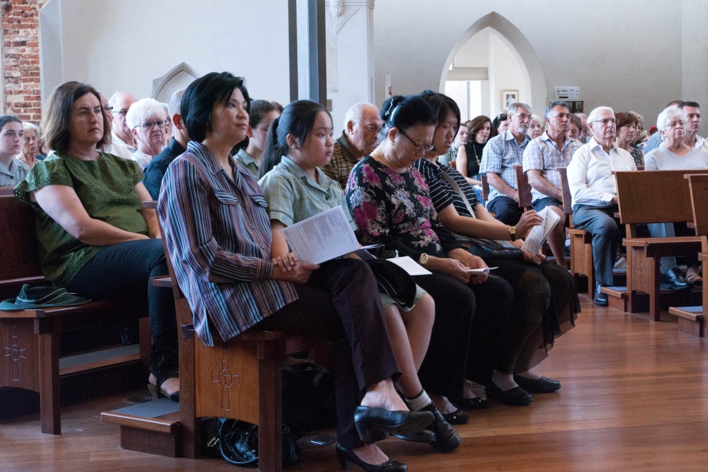 Mercedes College students and their grandparents receive a message about the importance of looking after others during Father Brennan Sia’s homily. Photo: Feby Plando.