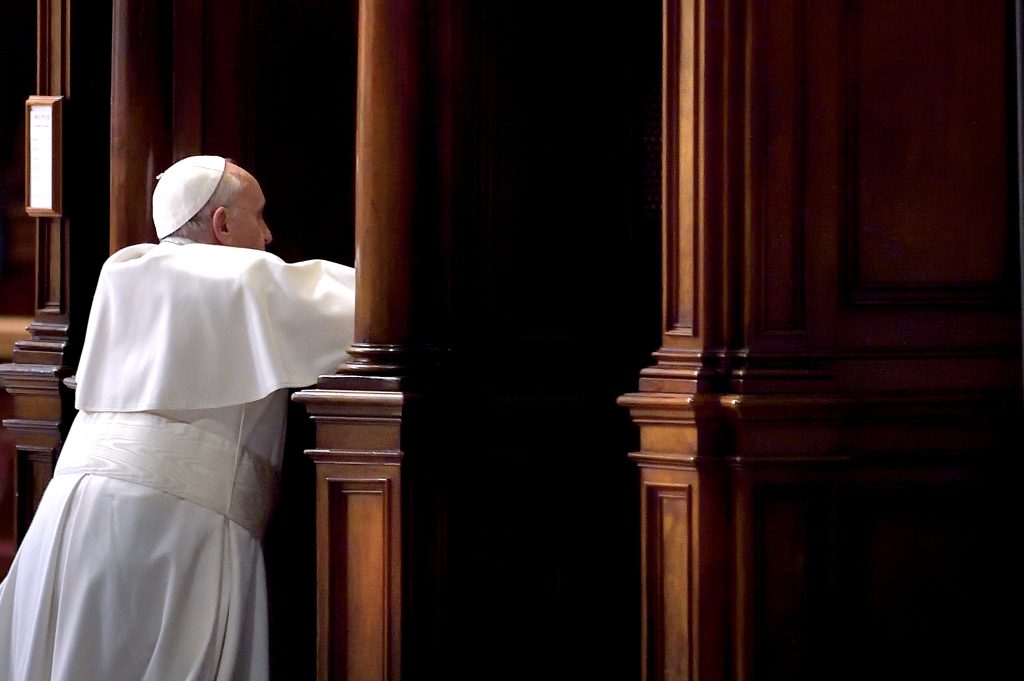 Pope Francis goes to Confession during a Lenten penance service in St Peter's Basilica at the Vatican on 13 March 2015. During the service, the Pope announced an Extraordinary Jubilee Year of Mercy to be celebrated from 8 December 2015, until 20 November 2016. Photo: CNS/Stefano Spaziani