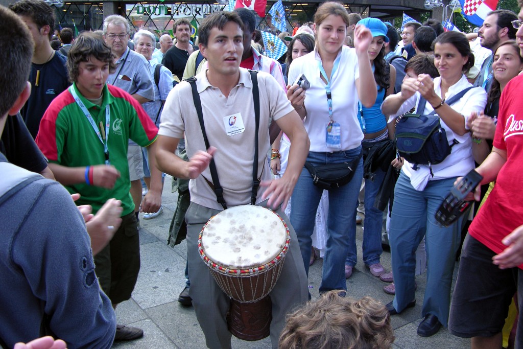 A young man plays his drum outside the Cathedral in Cologne, Germany, for World Youth Day 2005. Photo: Jamie O’Brien.