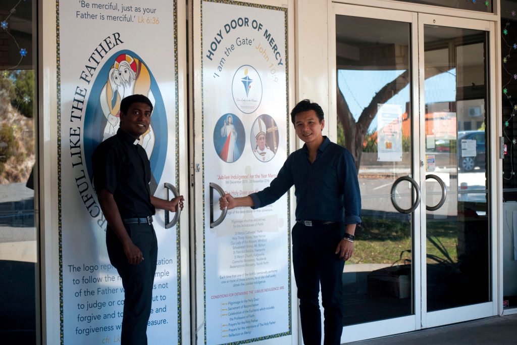 Parish Priest Fr Joseph Tran and Assistant Priest Fr Renald Anthony at the Whitford Holy Door. Photo: Caroline Smith