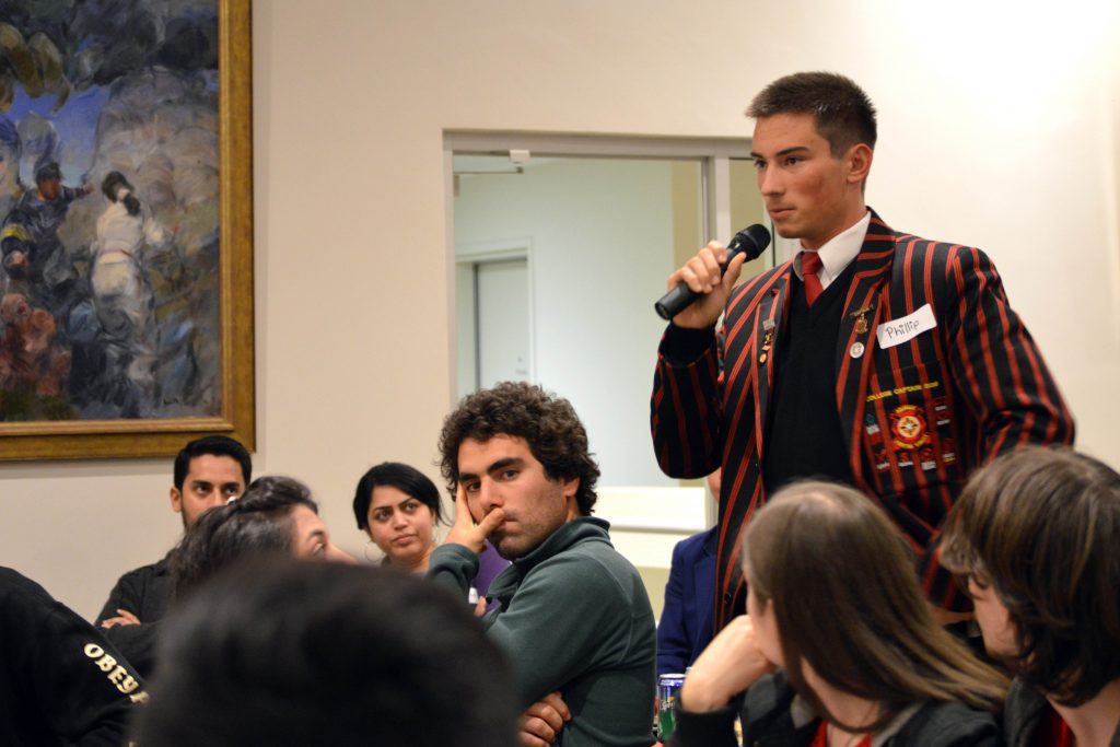 Head Boy of Aquinas College, Phillip Colic, asks Archbishop Costelloe SDB a question on whether religious education should be compulsory in all year levels in Catholic schools. Photo: Feby Plando