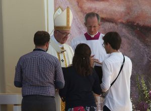 Pope Francis greets young people as he celebrates the World Youth Day closing Mass July 31 at the Field of Mercy in Krakow, Poland. (CNS photo/Bob Roller) See POPE-POLAND-WYD-MASS July 31, 2016.