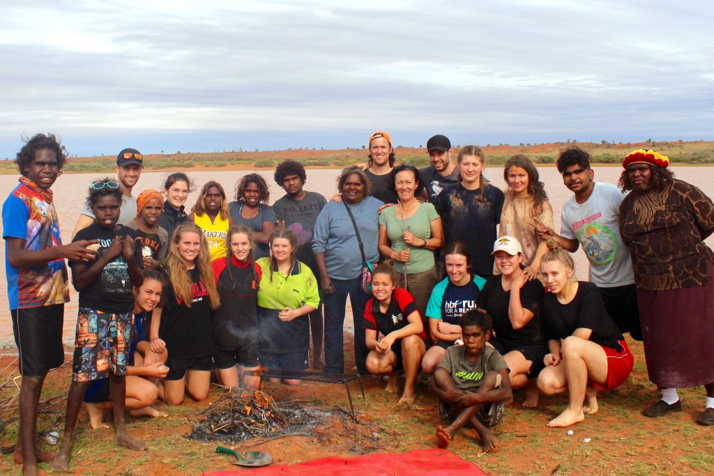 Santa Maria College has celebrated reaching the 10-year milestone of its partnership with the remote Aboriginal community of Punmu. Pictured are staff and students from the 2016 trip with members of the Punmu Community. Photo: Supplied