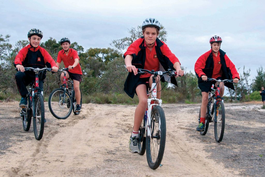 Aquinas College students mountain bike within the college’s bushland area during physical education class. Their teacher, Mr Dowling, believes living a healthy requires looking after the internal, as well as the external, aspects of one’s body. Photo: Marco Ceccarelli