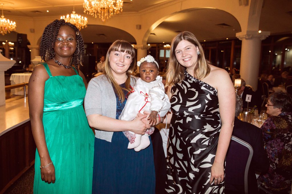 Grateful beneficiary of Pregnancy Assistance Juliana George (mother of Amayiah), Pregnancy Assistance volunteers Camille O'Brien holding baby Amayiah and Board Secretary Laura Craig. Photo: Monica Defendi Photography