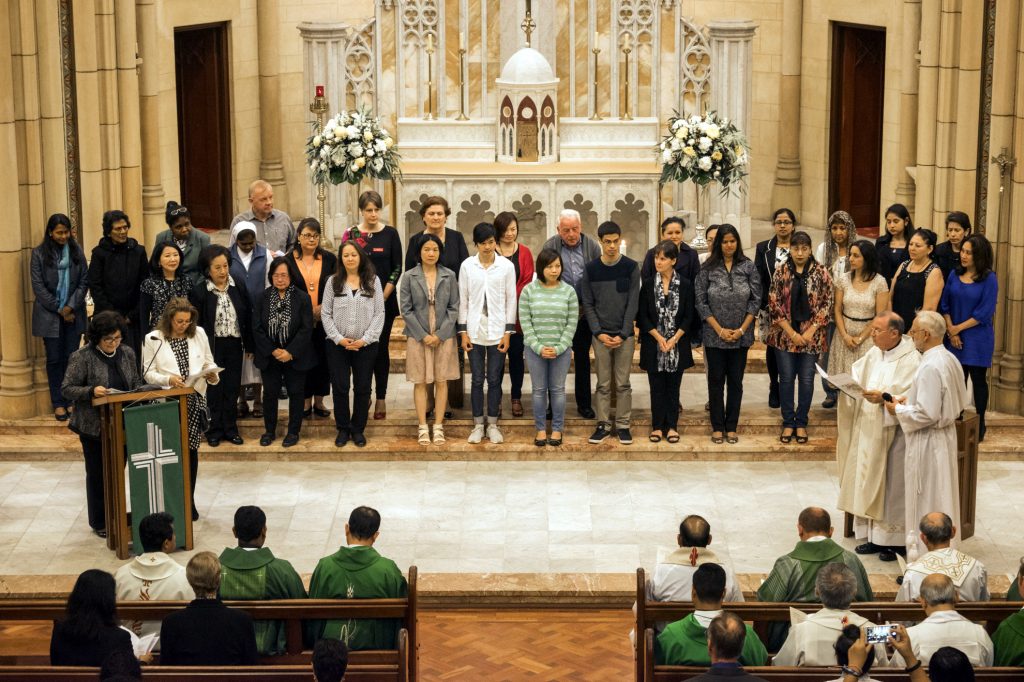 Catechists for the Parish Religious Education Program, Rite of Christian Initiation of Adults and Personal Advocacy Service assemble before the congregation to be commissioned and blessed. Photo: Jesse Roberts