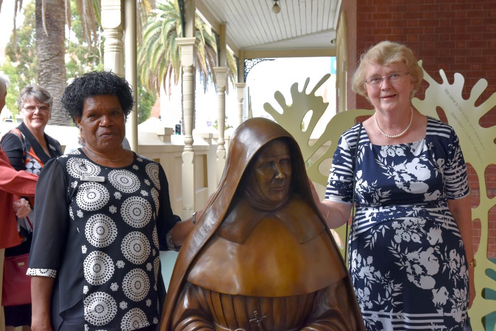 Members of the Leadership Team of the Institute of the Sisters of Mercy Australia and Papua New Guinea, Sister Theresia Tina and Sister Barbara Bolster, stand behind the newly unveiled bronze statue of Ursula Frayne at the Mercy Heritage Centre. Photo: Feby Plando