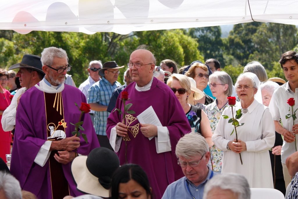 Representatives including Father Denis Foley from the Schoenstatt Diocesan Priests Institute and Armadale Parish Priest Fr Kaz Stuglik present a gift of 25 roses during the celebrations for the Schoenstatt Shrine’s Silver Jubilee. Photo: Chris Quinn