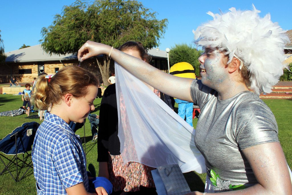 Attendees at Kolbe Catholic College’s ‘Carols on the Avenue’ event on 8 December were met with ‘angels’ who greeted them by sprinkling glitter. Photo: Supplied