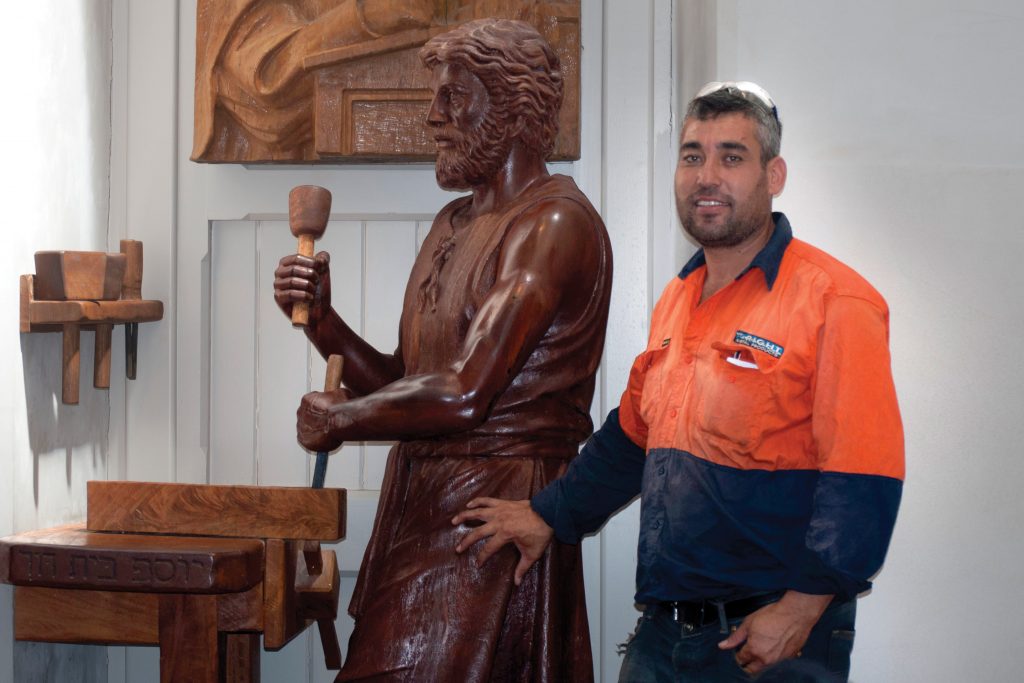 Mehdi Rasulle with the statue of St Joseph which he created for St Mary’s Cathedral in 2012. Photo: Caroline Smith