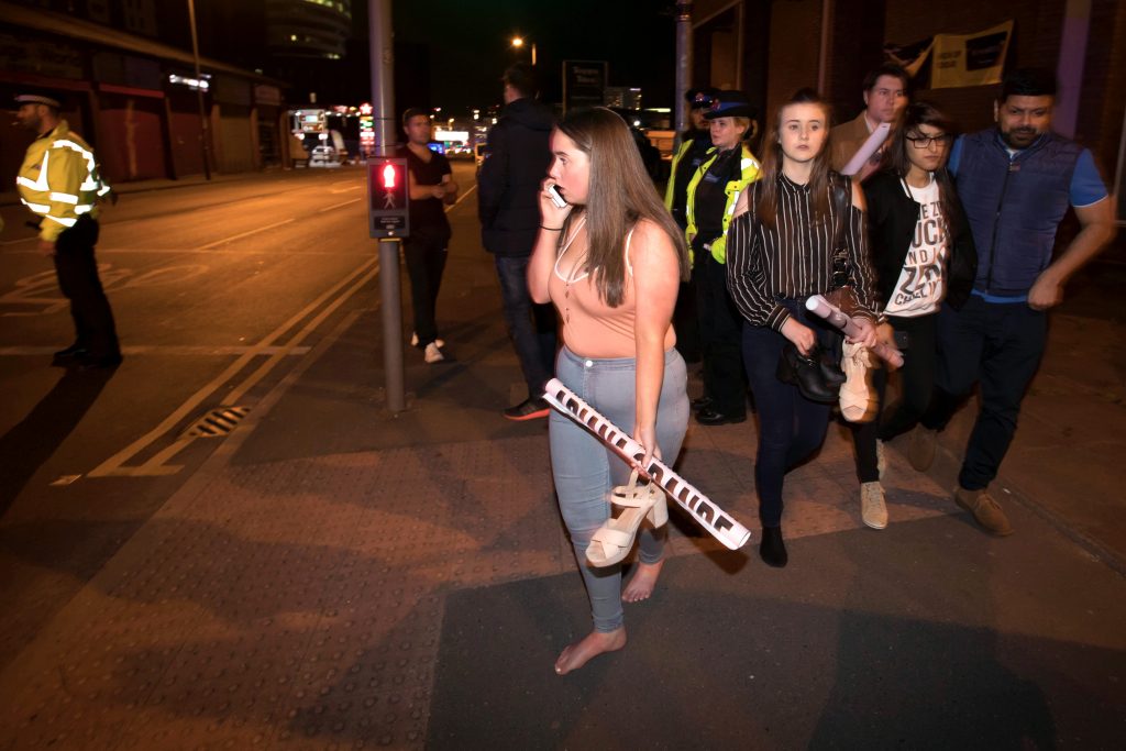 Concertgoers react after fleeing Manchester Arena in England where US singer Ariana Grande had been performing on 22 May. At least 22 people, including children, were killed and dozens wounded after an explosion at the concert venue. Authorities said it was Britain's deadliest case of terrorism since 2005. Photo: CNS/Jon Super.