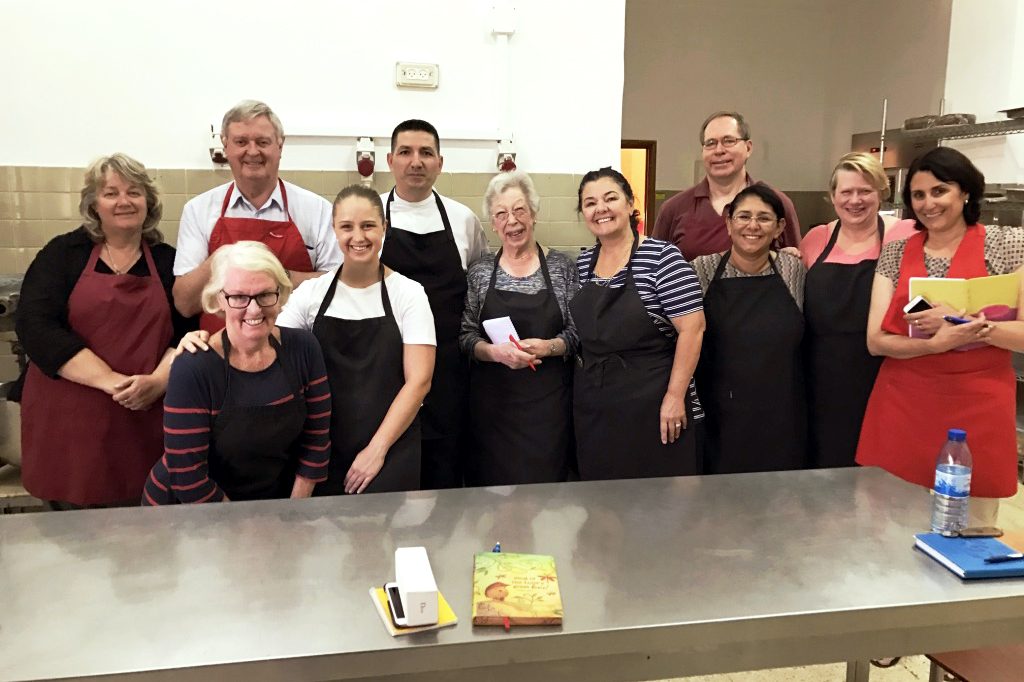 Perth pilgrims partaking in a Middle Eastern Cooking Class with Tantur Chef, Issa. Photo: Gemma Thomson.