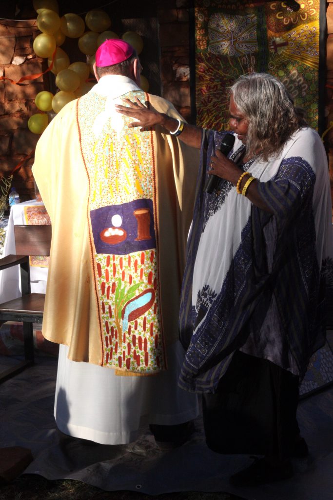 Balgo artist Magda Lee with Bishop Chris Saunders of Broome, explaining her artwork on his vestments. Photo: Supplied