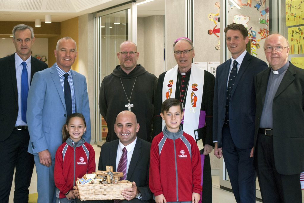 State Member for Darling Range, Tony Simpson; Catholic Education WA Executive Director, Dr Tim McDonald; Abbot of New Norcia, Fr John Herbert OSB; Auxiliary Bishop Don Sproxton; Federal Member for Canning, Andrew Hastie; and Armadale Parish Priest, Fr Kaz Stuglik (back) with Salvado Catholic College Principal, Santino Giancono, and students (front). Photo: Rachel Curry.