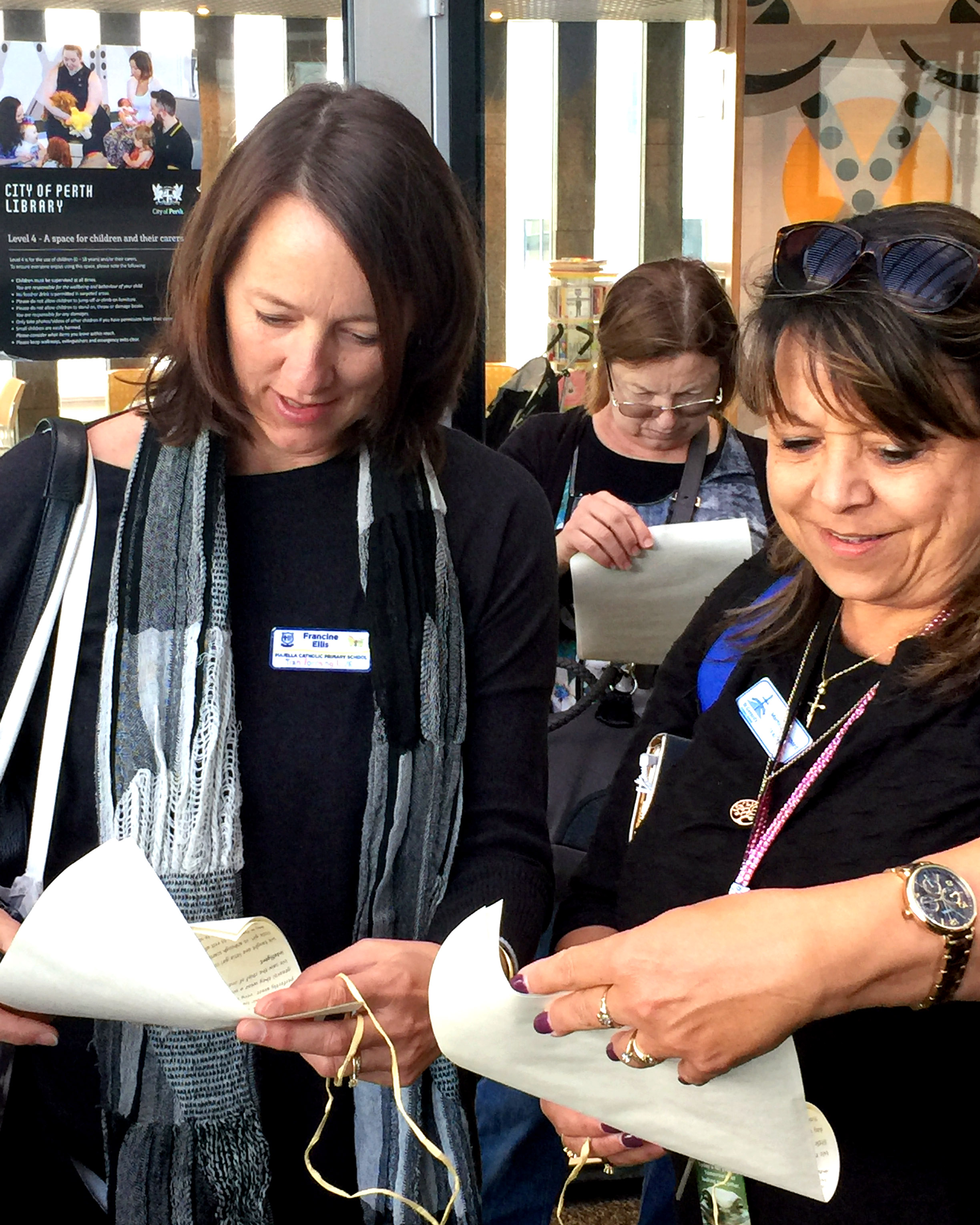 Fran Ellis, Halina Laurence, and Martine Sheppard read letters from Ursula Frayne to the Reverend mother in Ireland in the Perth City Library. Photo: Supplied. 