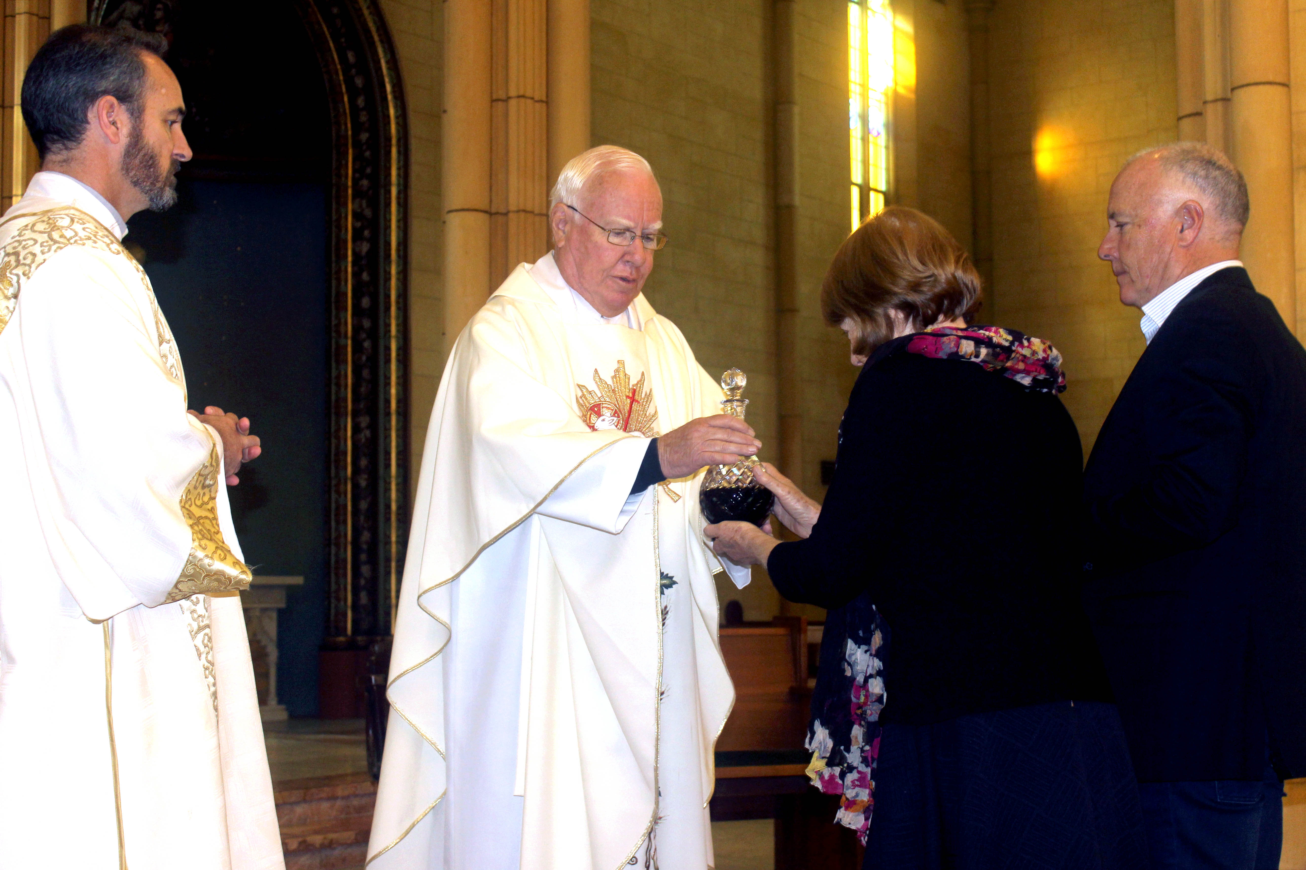 Fr Vincent Conroy with his sister Clare Evans and brother Peter Conroy bringing up the offertory gifts at his 50th anniversary Mass. Photo: Supplied.