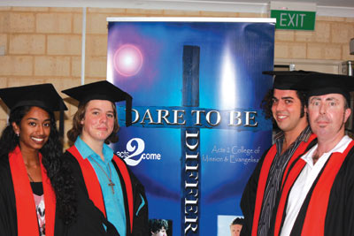 “Dare to be Different” is printed on the Acts2 banner behind graduates of 2011. 