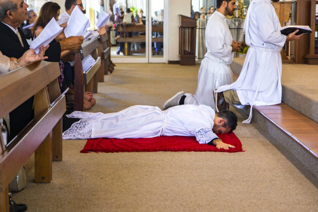 Br Chris de Sousa prostrates before the altar during his Ordination to the Diaconate on 3 November 2018 at St Jerome’s Church, Spearwood. Photo: Matthew Lau.