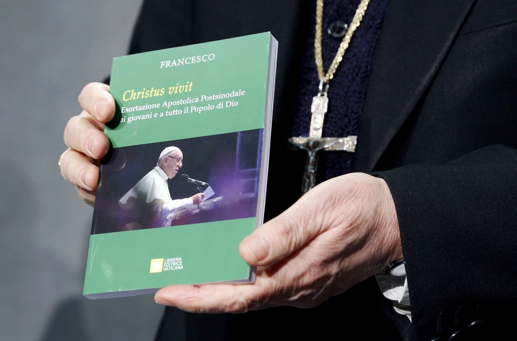 Cardinal Lorenzo Baldisseri, Secretary-General of the Synod of Bishops, holds Pope Francis' Apostolic Exhortation, “Christus Vivit" (Christ Lives), during a news conference for its presentation at the Vatican 2 April, 2019. The document contains the Pope's reflections on the 2018 Synod of Bishops on young people, the faith and vocational discernment. Photo: CNS/Paul Haring.