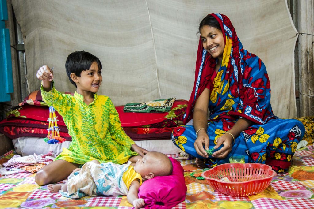 Salma spends quality time with her newborn baby boy Samiul and her daughter Maya. They tell stories and play games. Photo: Ashish Peter Gomes/Caritas Australia.