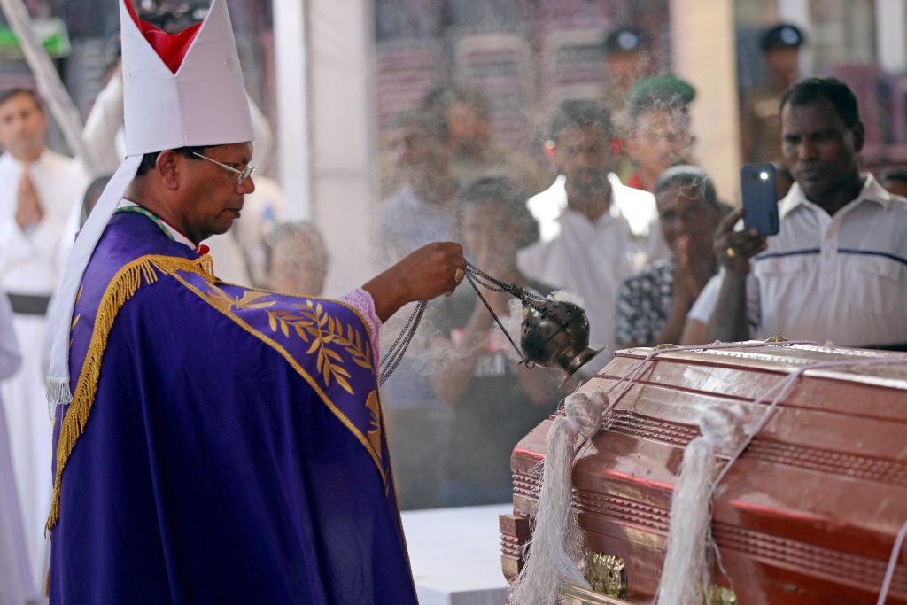 A prelate swings a censer over the casket of a victim during a funeral Mass in Negombo, Sri Lanka, on 24 April, three days after a string of suicide bomb attacks on churches and luxury hotels across the island. Photo: Athit Perawongmetha/Reuters.