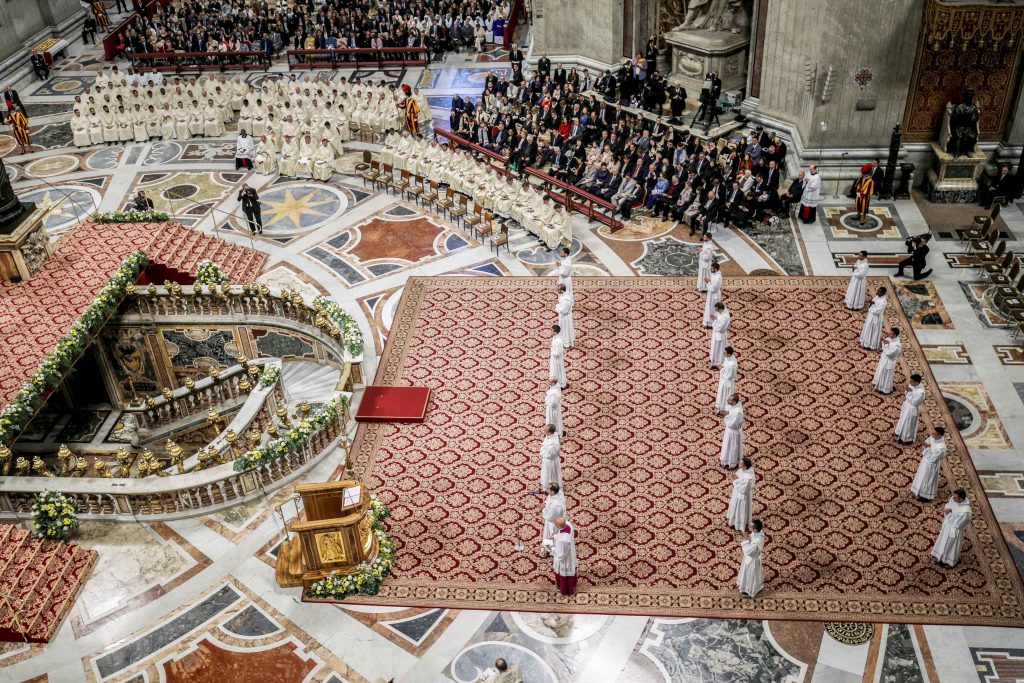 Newly ordained priests stand as Pope Francis celebrates an ordination Mass in St Peter's Basilica at the Vatican on 12 May 2019. The Holy Father ordained 19 new priests. Photo: Giuseppe Lami/Reuters.