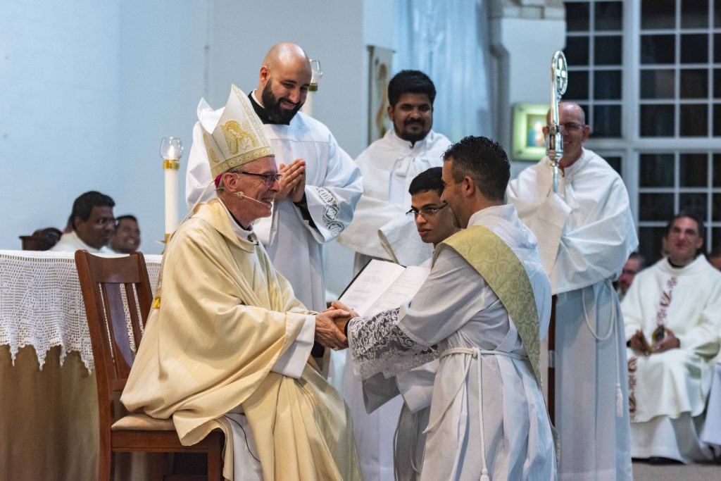 Fr Christopher John Maria De Sousa CRS led in his holy vows by Auxilery Bishop of Perth, Donald Sproxton. Photo: Matt Lau.