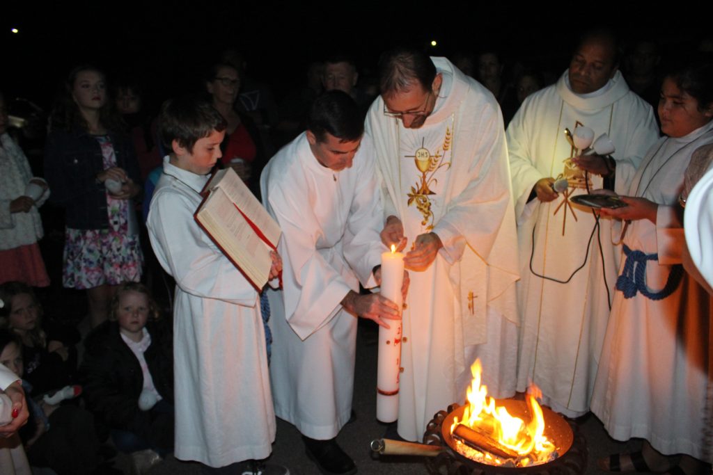 Fr Vajra blessing the Baptismal fire before the Easter Vigil Mass that took place at the Rockingham Parishon 20 April. Photo: Supplied.