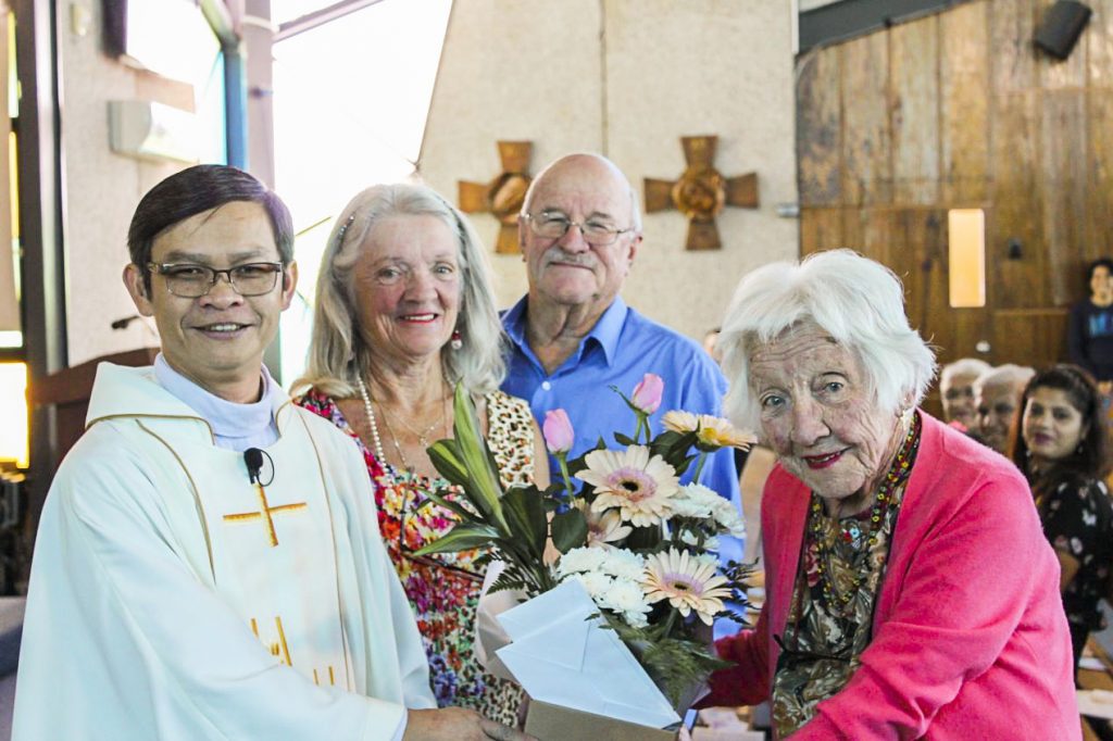 Sheelah Rudman with daughter Barbara, son-in-law Bruce Walther, and Fr Quynh during birthday celebrations after Sunday Mass. Photo: Sunil Rodrigues.