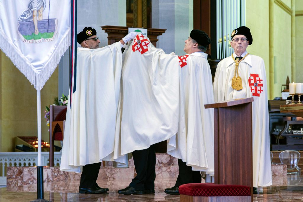 Lt Kevin Susai is receives his new regalia from his fellow Knights of the Holy Sepulchre of Jerusalem. Photo: Eric Martin.